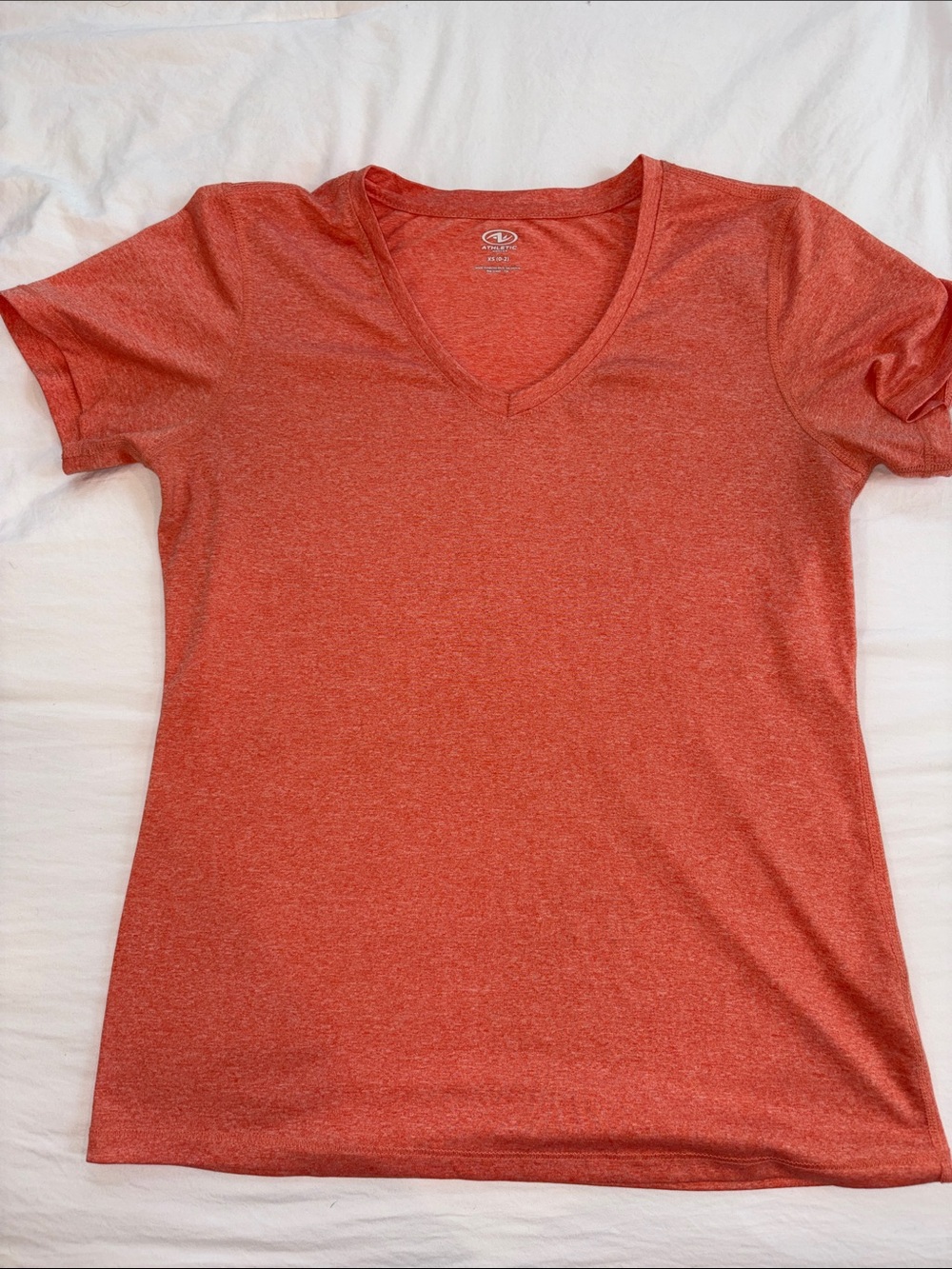 Women’s V neck Athletic Shirt. Light orange/peach.